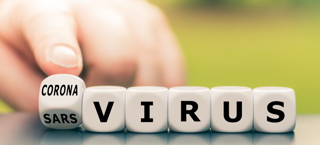 Hand turns a dice and changes the expression "sars virus" to "corona virus".